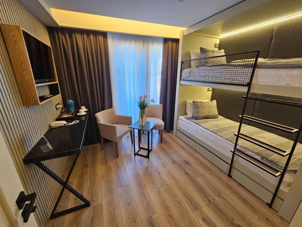 a small room with a bunk bed and a desk at Anthemis Hotel in Istanbul