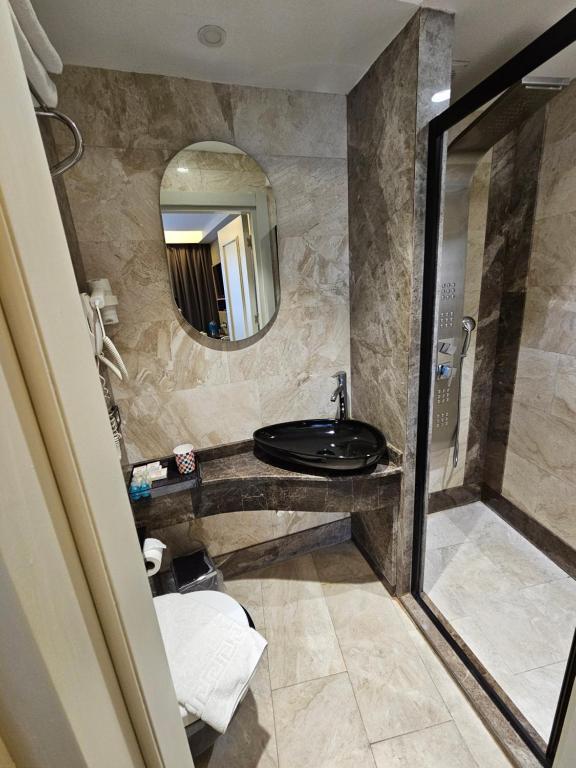 a bathroom with a sink and a mirror at Anthemis Hotel in Istanbul