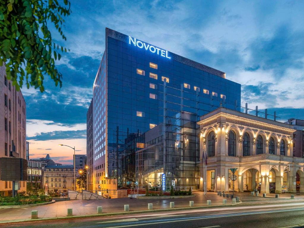 a building with a sign on the side of it at Novotel Bucharest City Centre in Bucharest
