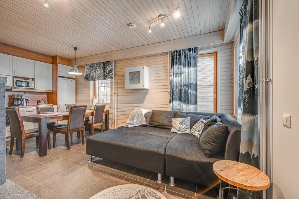 a living room with a couch and a table at Länsirinne 9 C in Ruka