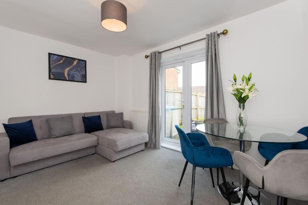 a living room with a couch and a table and chairs at Grange Way in Bowburn