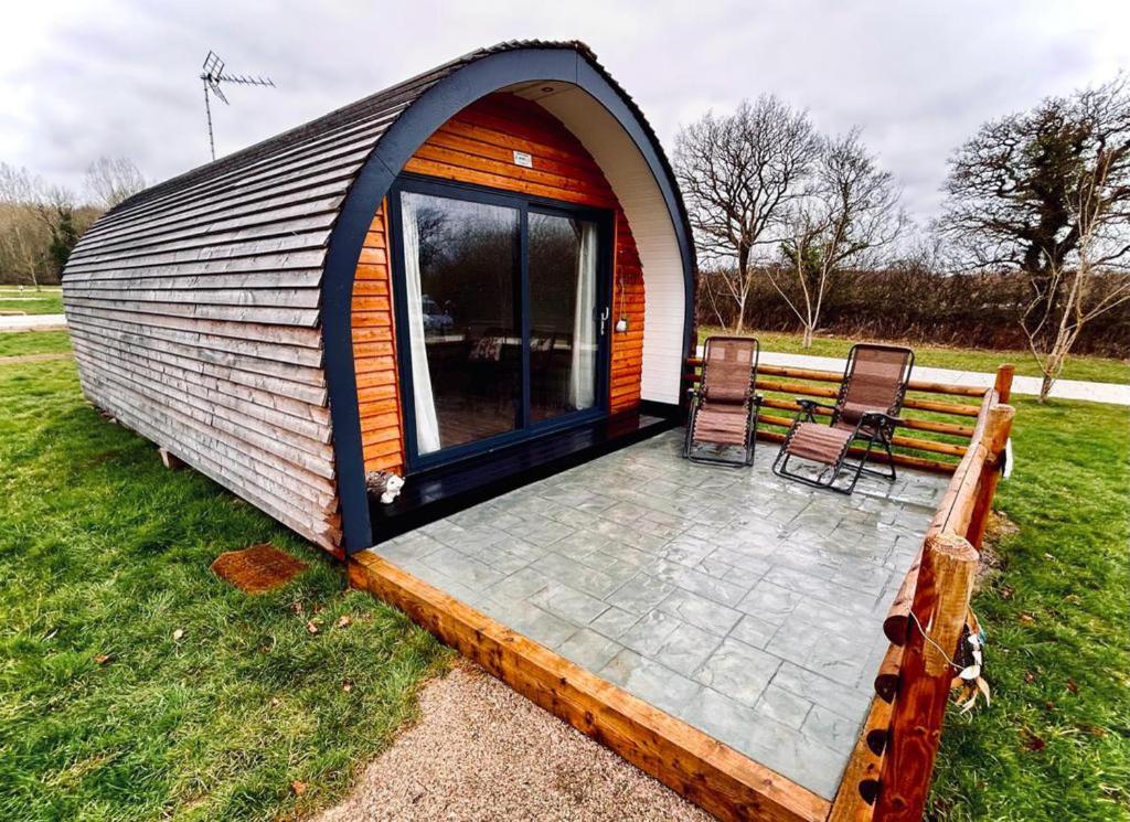 una casa a cupola con terrazza e due sedie di 1-Bed pod cabin in beautiful surroundings Wrexham a Wrexham