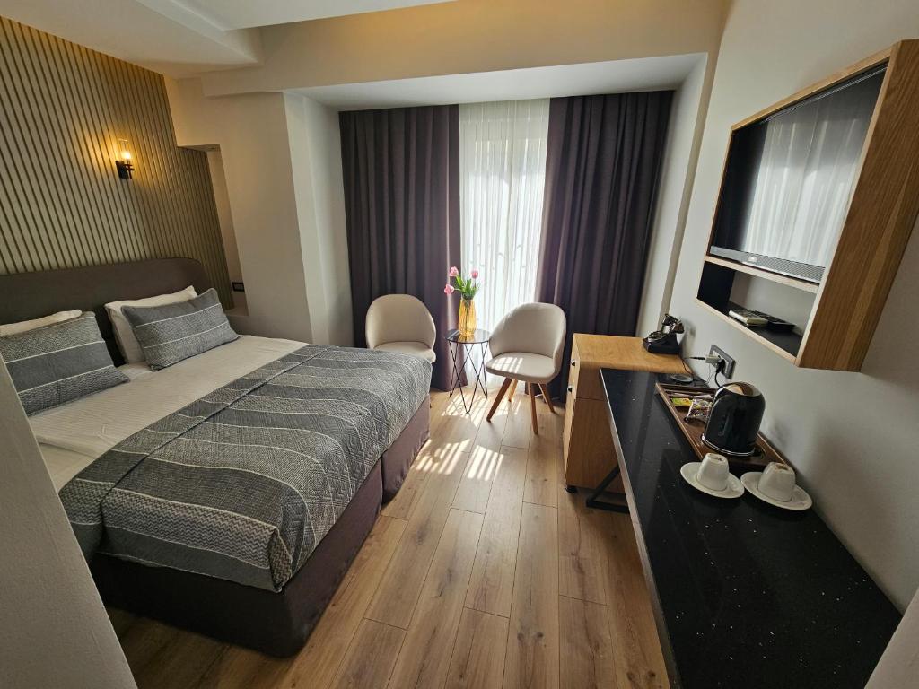 a hotel room with a bed and a television at Anthemis Hotel in Istanbul