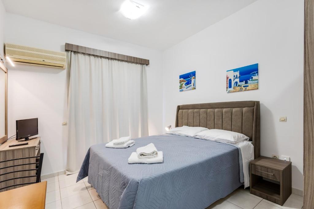 Postel nebo postele na pokoji v ubytování Johnhara Studios & Apartments