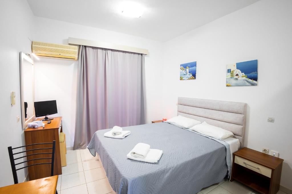 Postel nebo postele na pokoji v ubytování Johnhara Studios & Apartments
