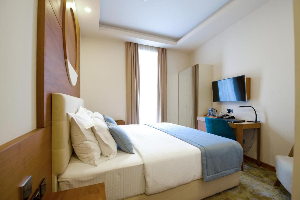 Postel nebo postele na pokoji v ubytování Hotel City Savoy