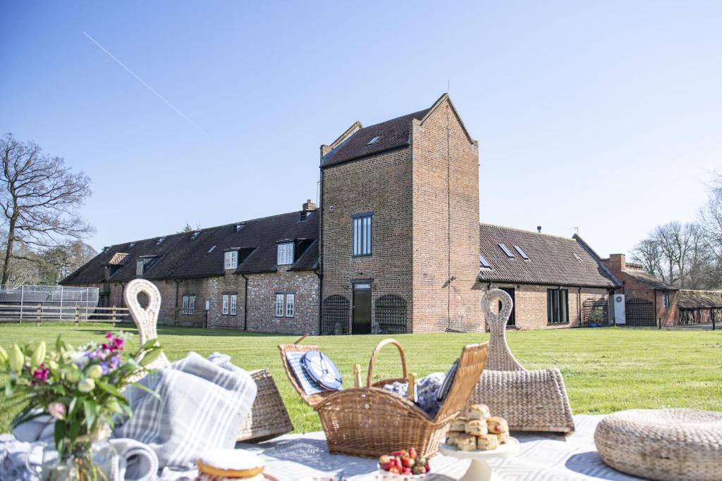 a picnic table with baskets on it in front of a building at Willowgarth House in Great Smeaton