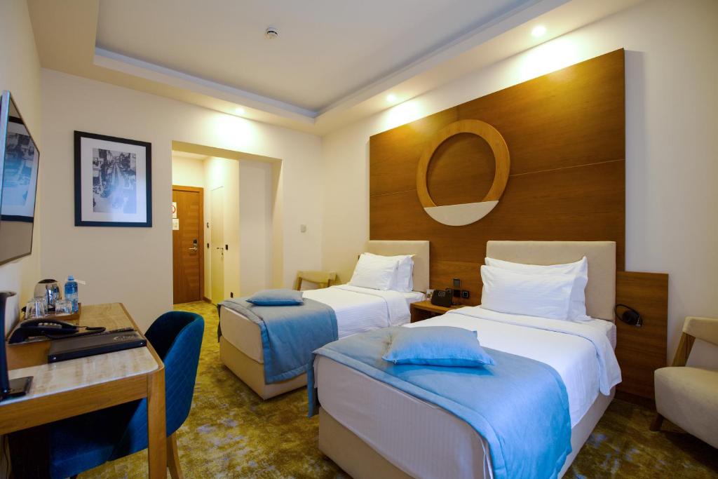 Postel nebo postele na pokoji v ubytování Hotel City Savoy