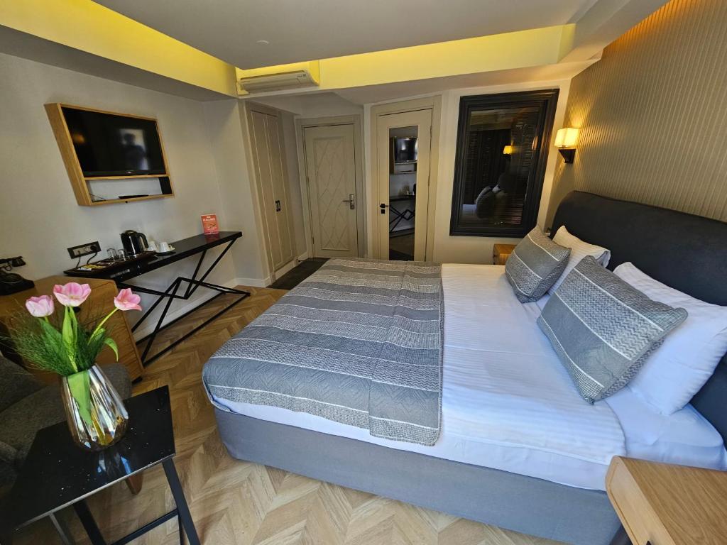 a bedroom with a large bed and a table at Anthemis Hotel in Istanbul