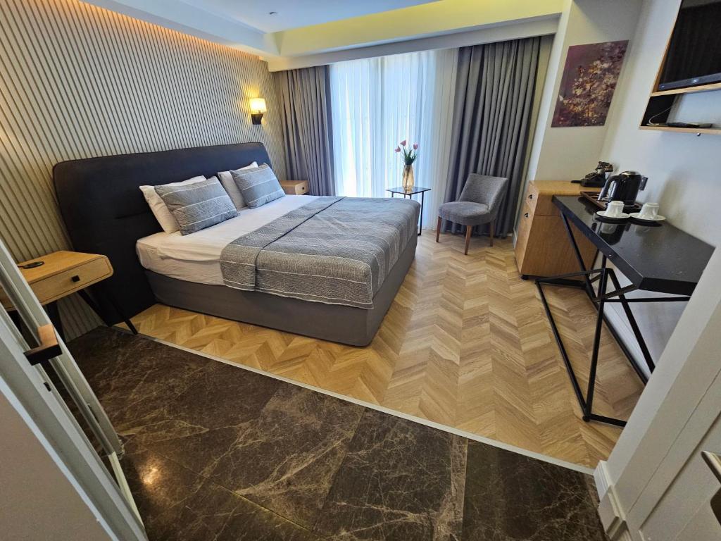 a hotel room with a bed and a desk at Anthemis Hotel in Istanbul