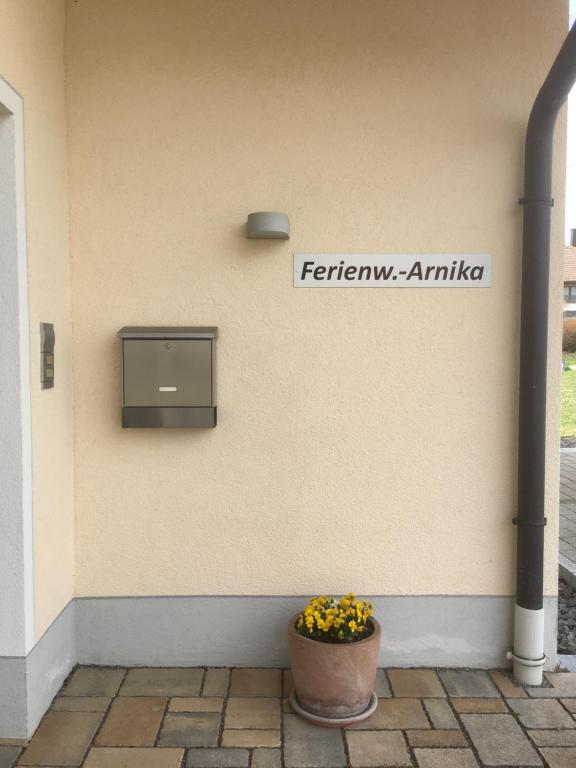 a flower pot sitting on the side of a building at Ferienwohnung Arnika 