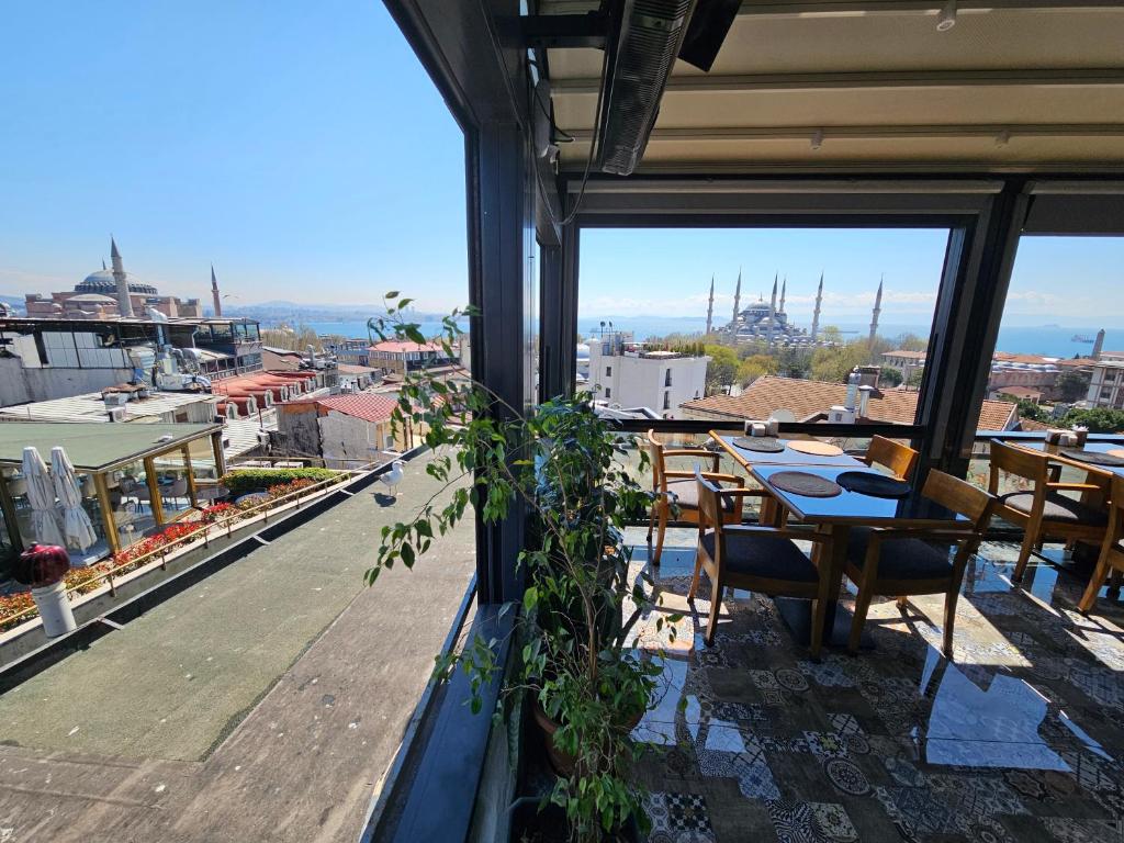 a balcony with a table and a view of a city at Anthemis Hotel in Istanbul