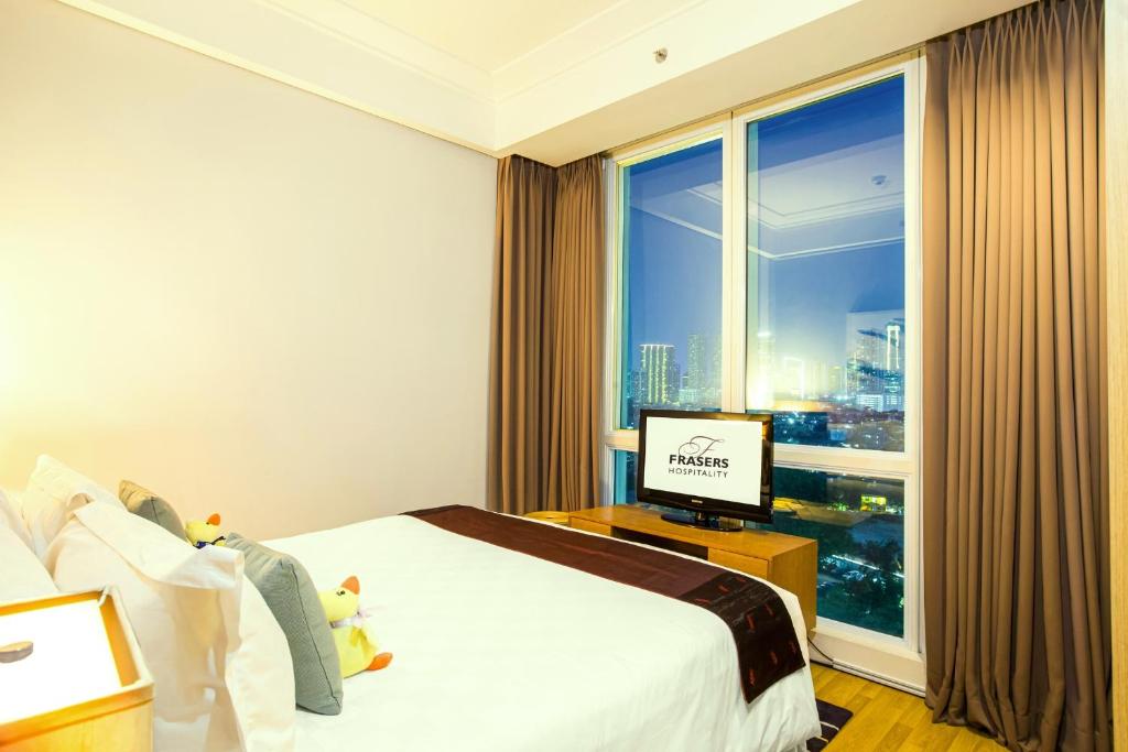 Postel nebo postele na pokoji v ubytování Fraser Residence Sudirman Jakarta
