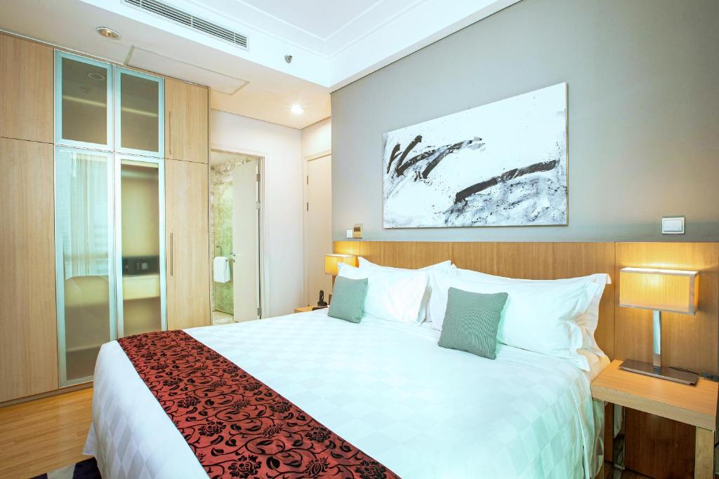 Postel nebo postele na pokoji v ubytování Fraser Residence Sudirman Jakarta