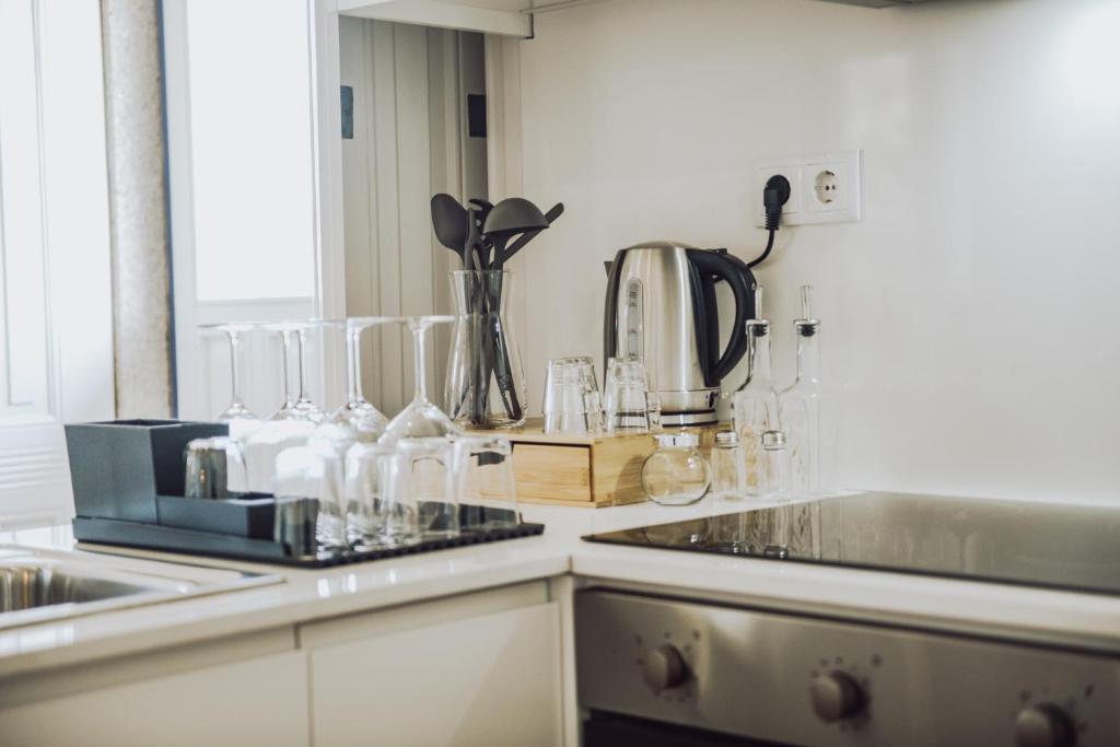 a kitchen with a counter top with glasses on it at Estação Ferroviária de Mondim de Basto in Celorico de Basto