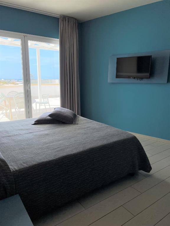 Postel nebo postele na pokoji v ubytování Tabù Hotel