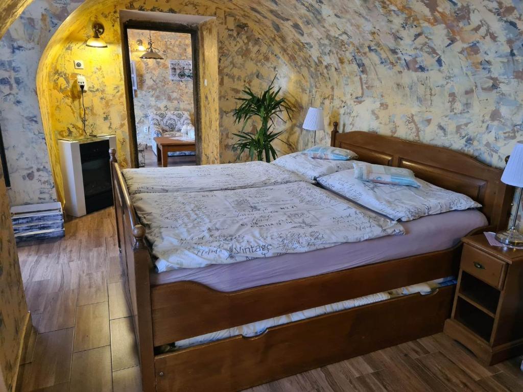 a bedroom with a bed in a room at Penzión na Trojice & Reštaurácia FORTUNE in Banská Štiavnica