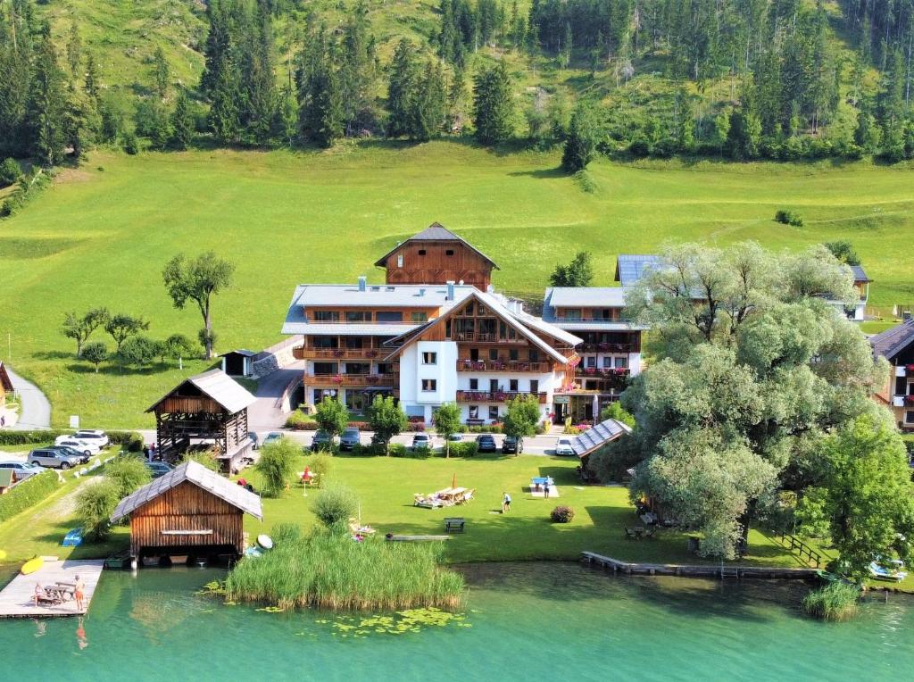 an aerial view of a resort with a lake at Ferienhof Neusacher Moser in Weissensee