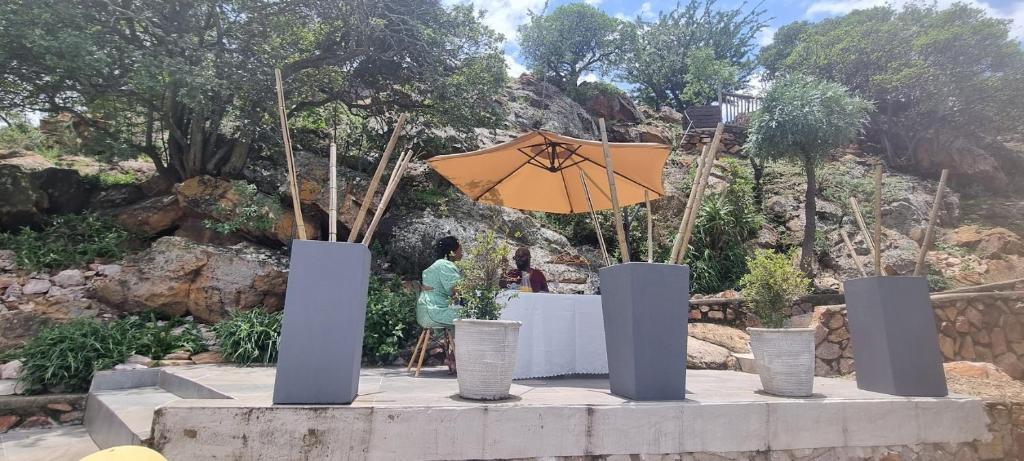 a table with an umbrella in a garden at The Throne in Johannesburg