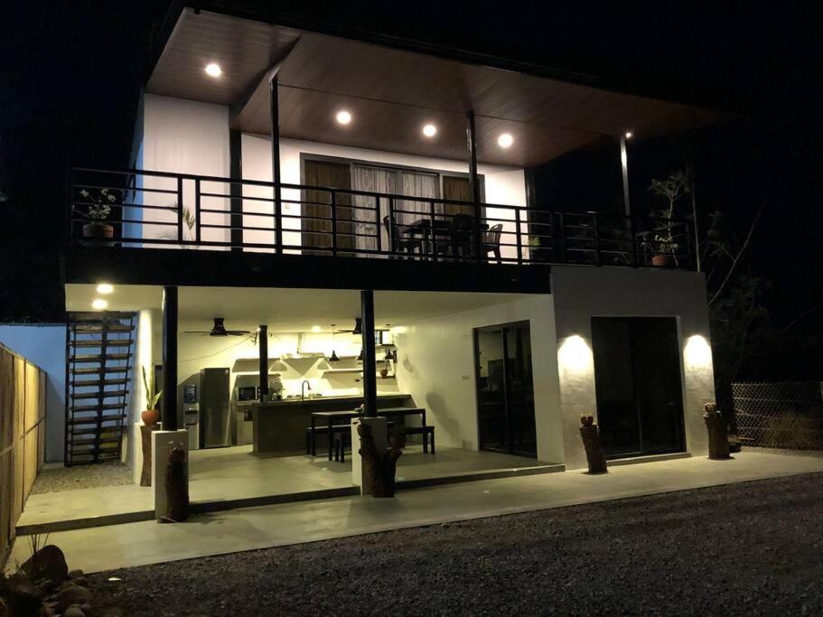 a house with a balcony on top of it at night at Sunset Hour in San Juan