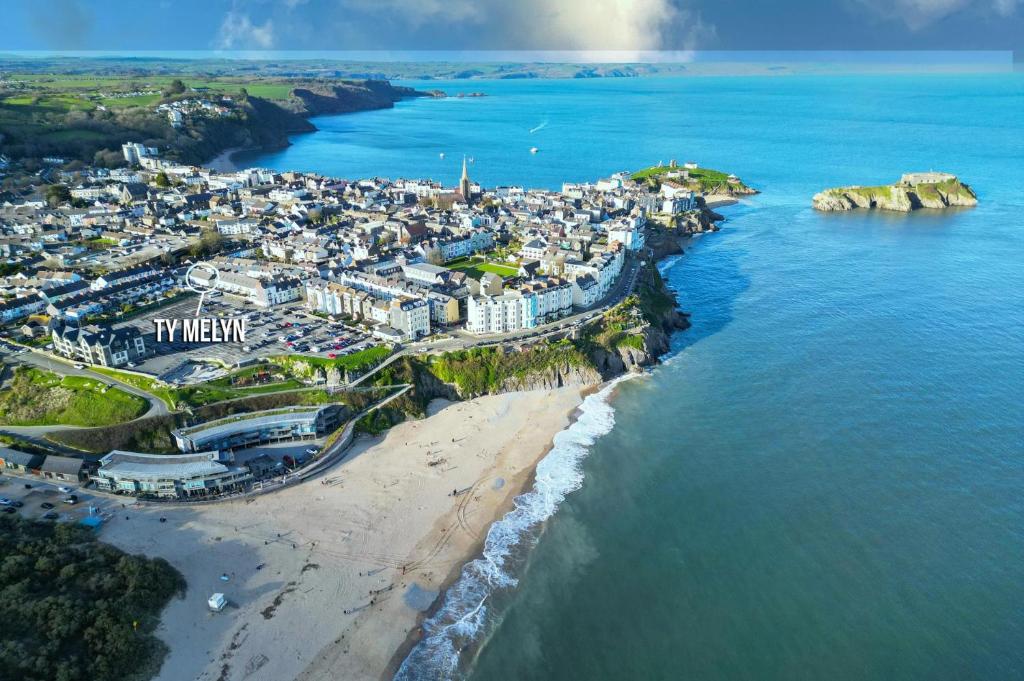 an aerial view of a city on the beach at Ty Melyn - 2 Bedroom Cottage - Tenby in Tenby