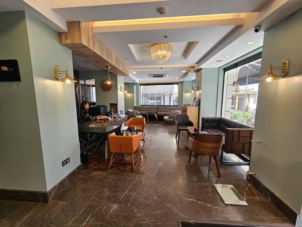 a lobby with a table and chairs in a room at Anthemis Hotel in Istanbul