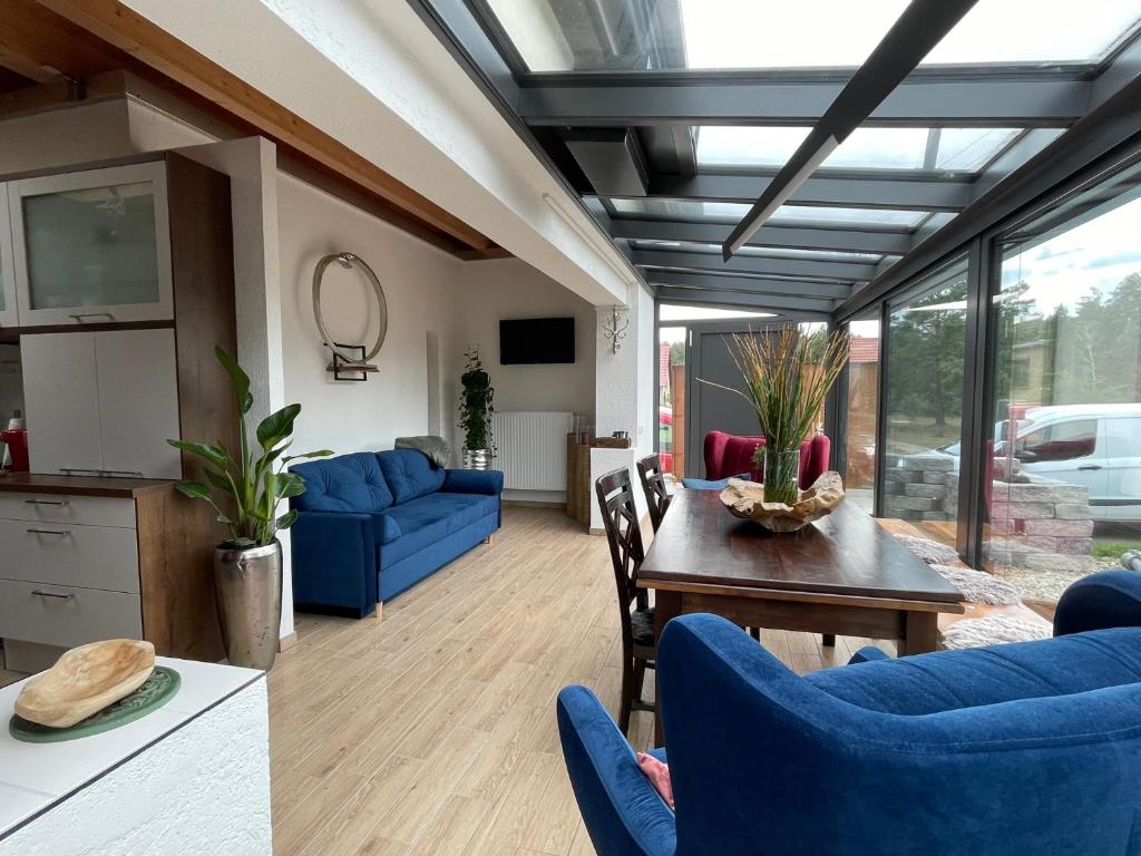 a living room with blue chairs and a table at Spreewaldhaus Widwan in Lübbenau