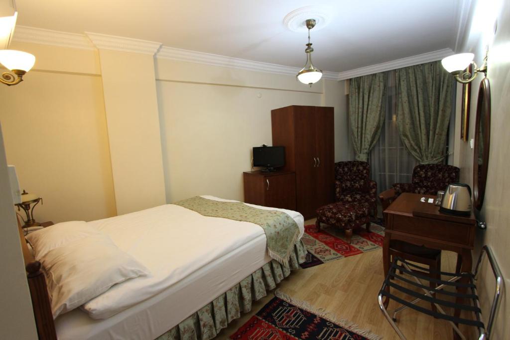 Postel nebo postele na pokoji v ubytování Basileus Hotel