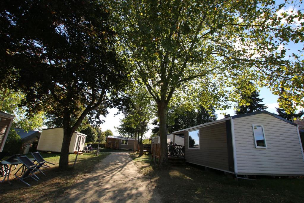 a campsite with a house and a tree at Loggia Camping Belle-Vue 2000 in Berdorf