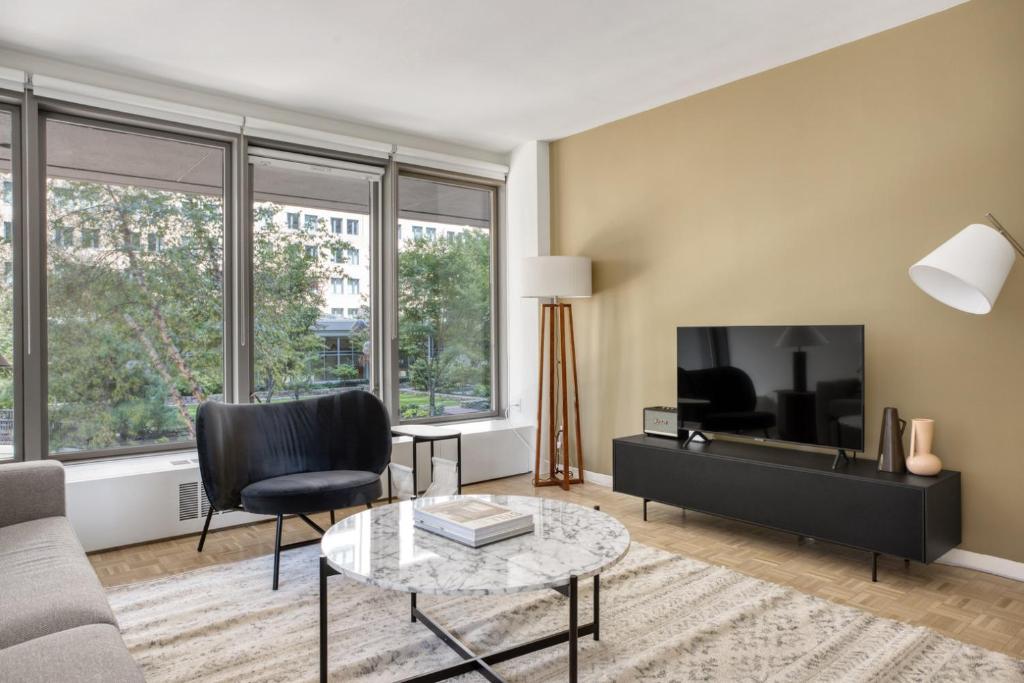 a living room with a couch and a tv at Back Bay 1BR w Gym nr Copley Sq BOS-739 in Boston