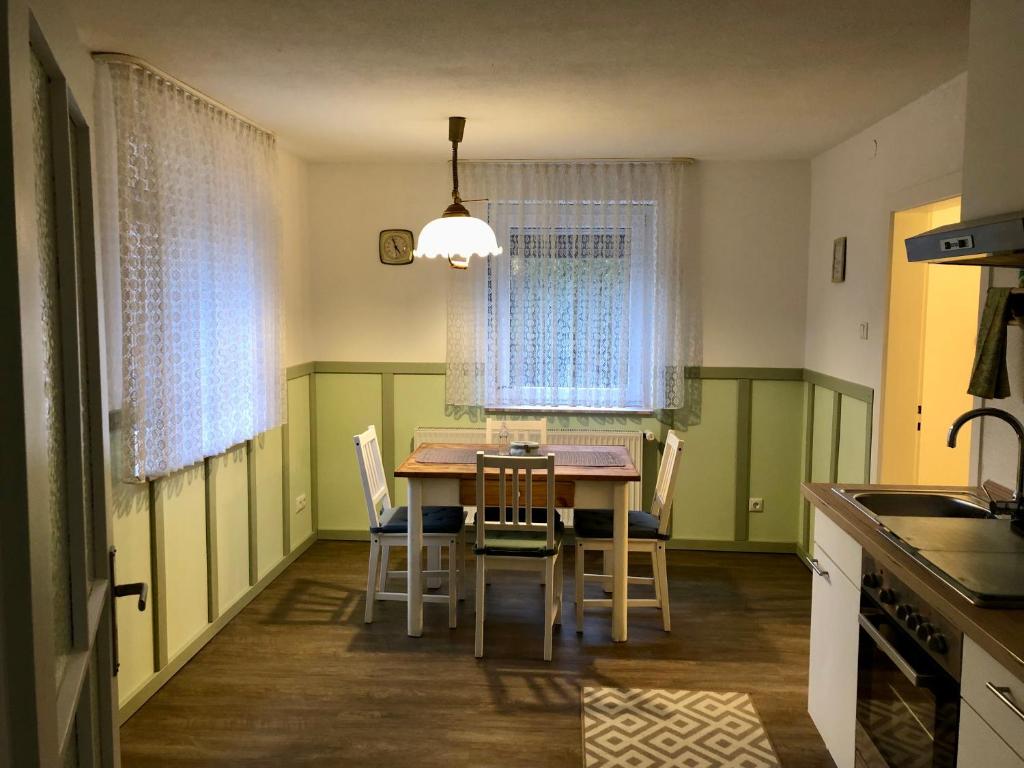 eine Küche mit einem Esstisch und Stühlen in der Unterkunft Villa Rosa in Bad Rodach
