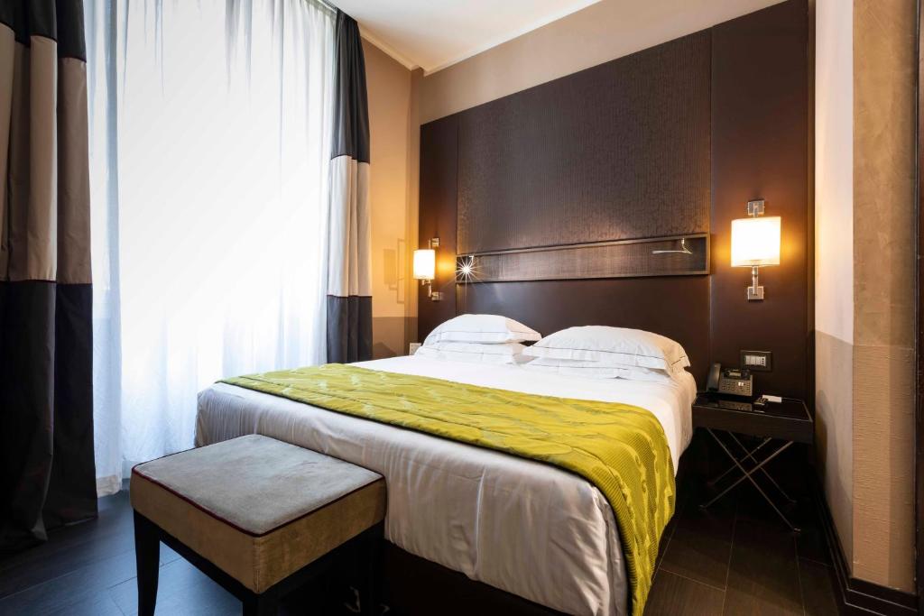 Postel nebo postele na pokoji v ubytování Rome Times Hotel