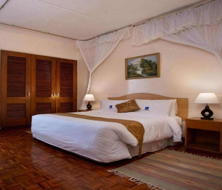 Postel nebo postele na pokoji v ubytování Chester Hotel and Suites Nairobi, City Centre CBD