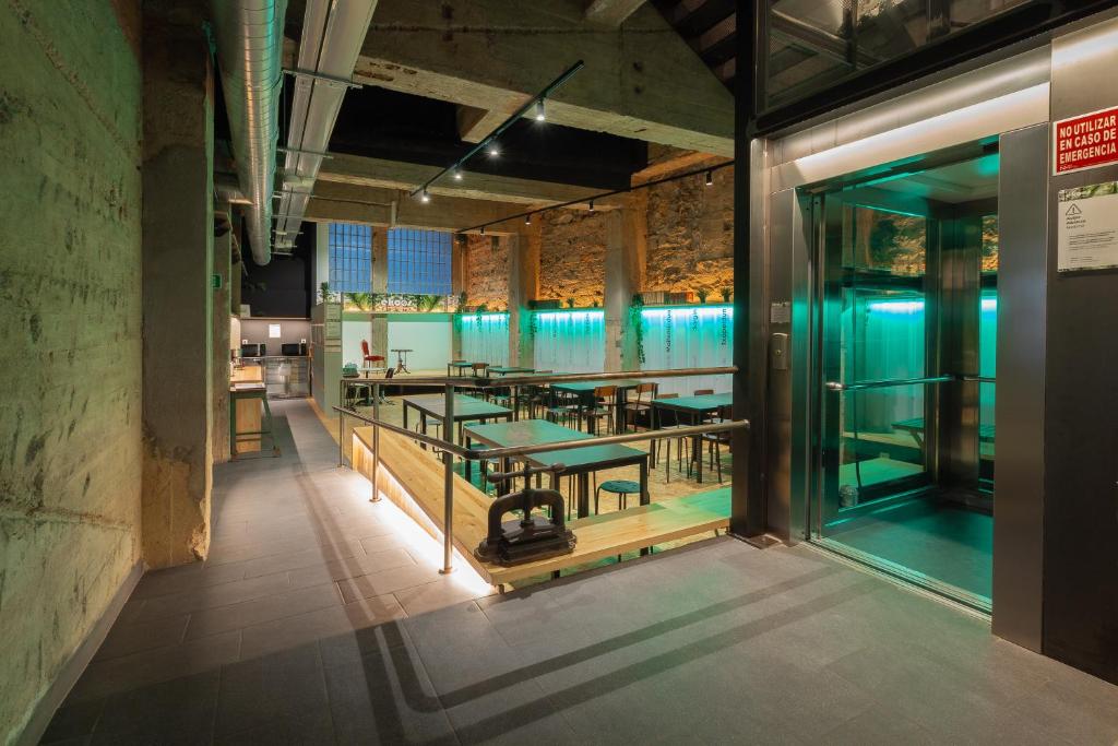 a dining room with tables in a building at Ekoos Hostel, Bilbao Eko Hostel in Bilbao