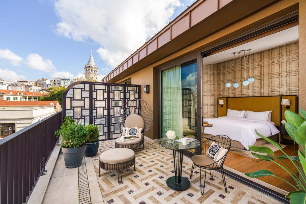 a hotel room with a bed and a balcony at The Galata Istanbul Hotel MGallery in Istanbul