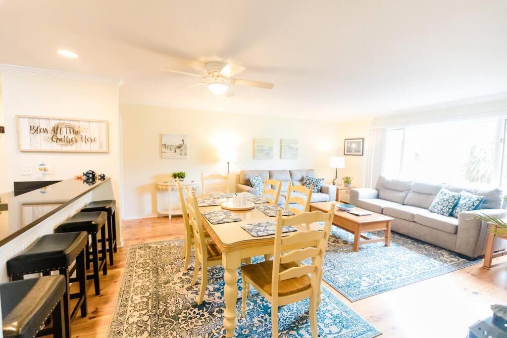 a living room with a table and a couch at Lagoon Villa 25 - Heart of Wild Dunes, Quick Walk to Beach in Isle of Palms