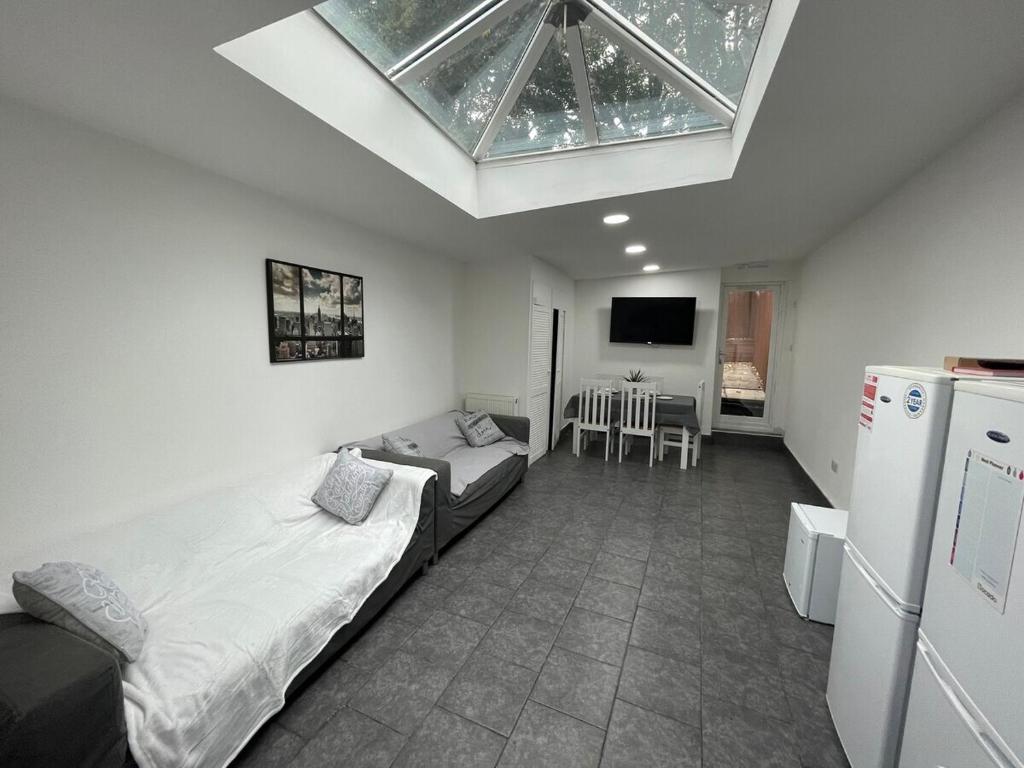 a bedroom with a large bed and a skylight at STAY SA Equipped Studios next to UOB and QE! in Birmingham