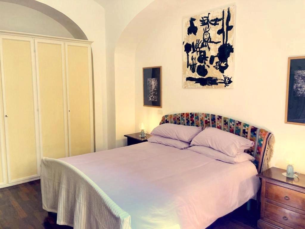 a bedroom with a large bed with two night stands at Lovely Apartment in Testaccio, Rome in Rome