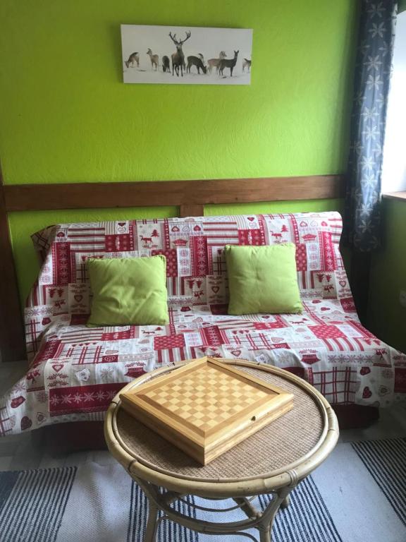 a bedroom with a bed with a tray on it at La Petite Finlande in Orbey