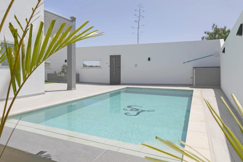 a swimming pool in the backyard of a house at Stunning Apartment - Near Los Cristianos in Chayofa