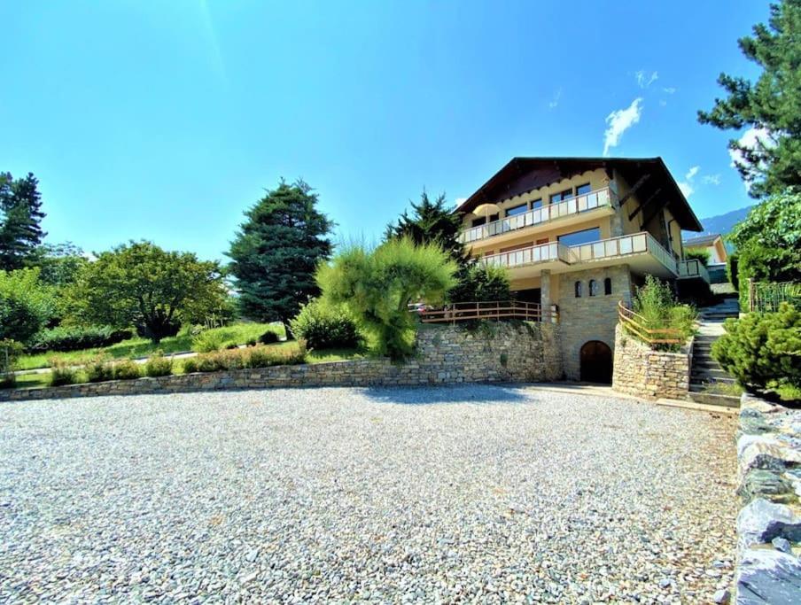 a large house with a gravel driveway in front of it at Spacieux, situation idéale pour visiter le Valais in Veyras