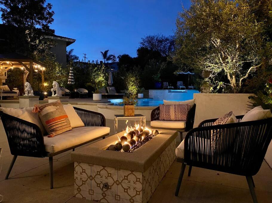 a patio with a fire pit with two chairs and a couch at Your Private Resort near Coast in Oceanside