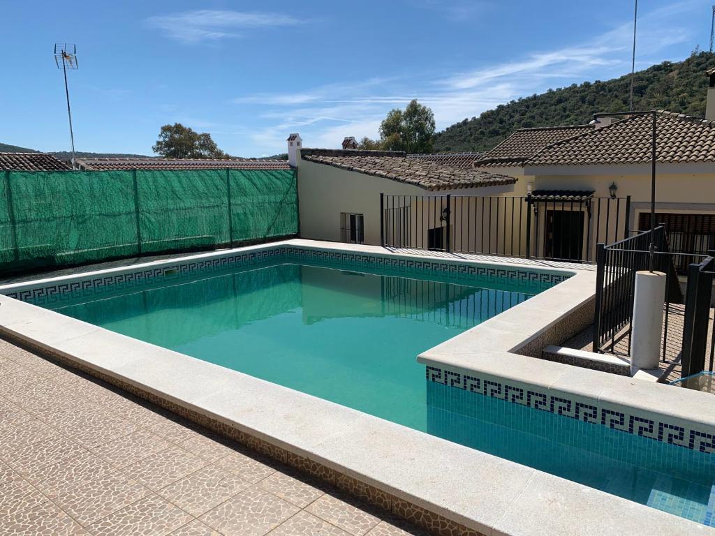 uma piscina no quintal de uma casa em Chalet El Madroño, en el Castillo de las Guardas. em Minas del Castillo de las Guardas