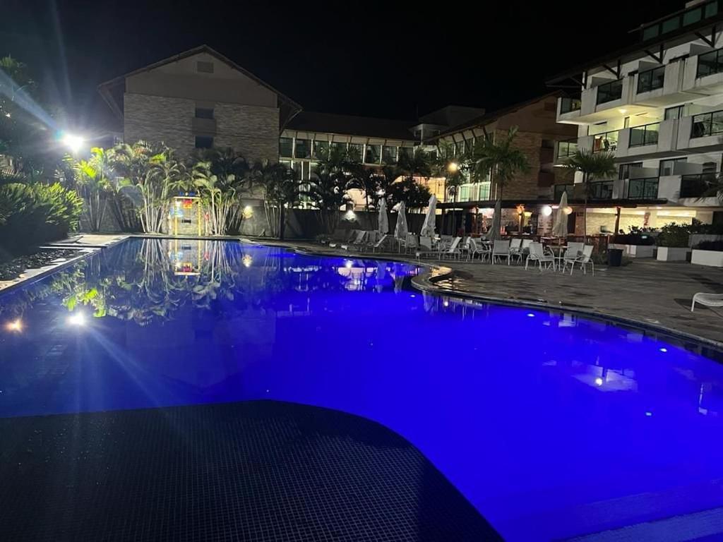 a swimming pool at night with blue illumination at Flat laguna Beach By Bispo in Porto De Galinhas