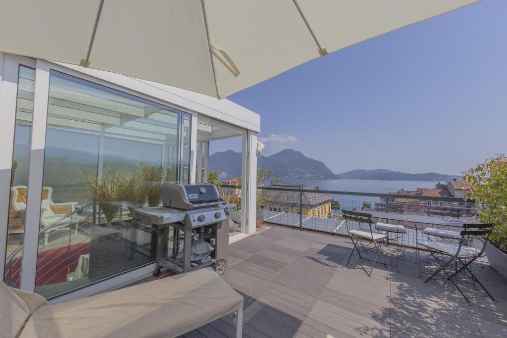 a grill on a patio with a view of the water at La Terrazza sul Lago in Verbania