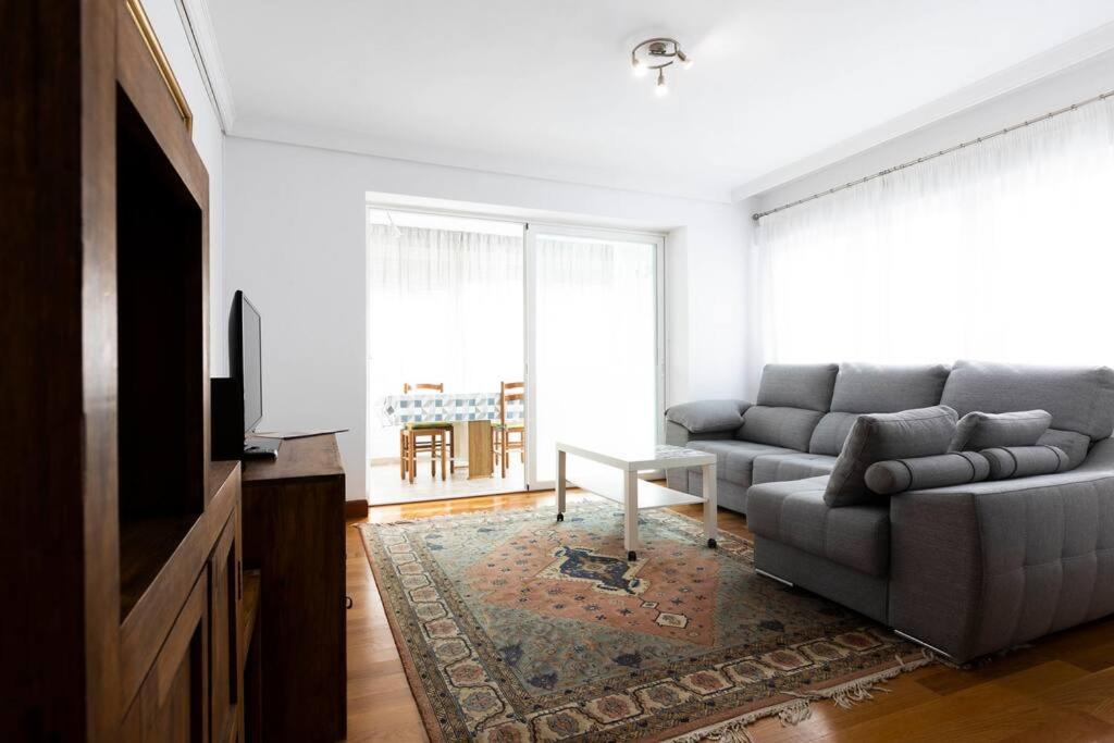 a living room with a couch and a tv at Zurubi-gain. Basquenjoy in Hondarribia