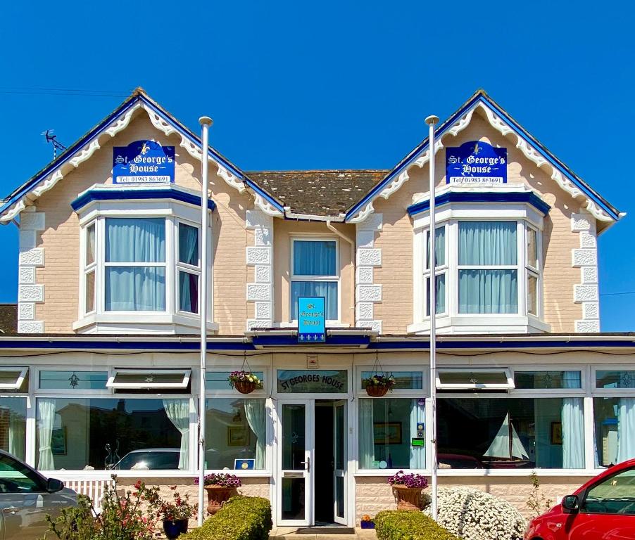 a building with blue signs on the front of it at St. Georges House in Shanklin