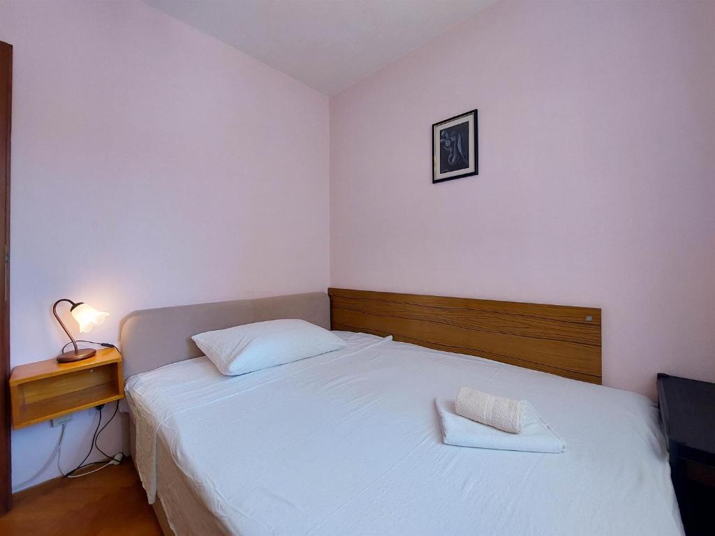 Postel nebo postele na pokoji v ubytování Apartments Nikola