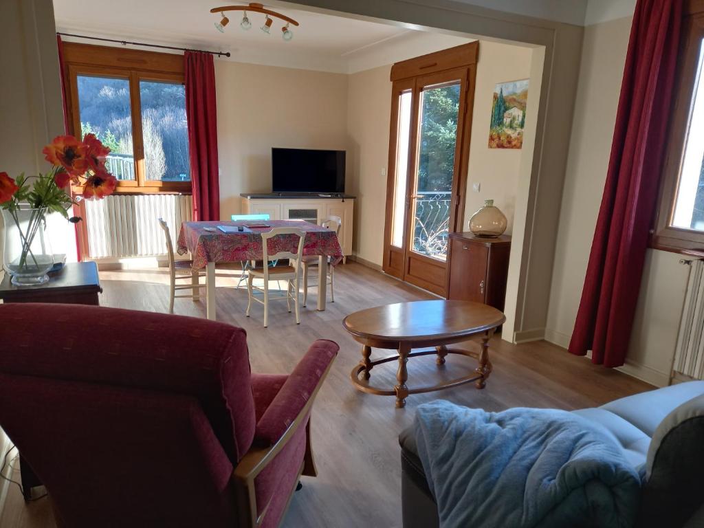 a living room with a couch and a table at residence emile in Meyras