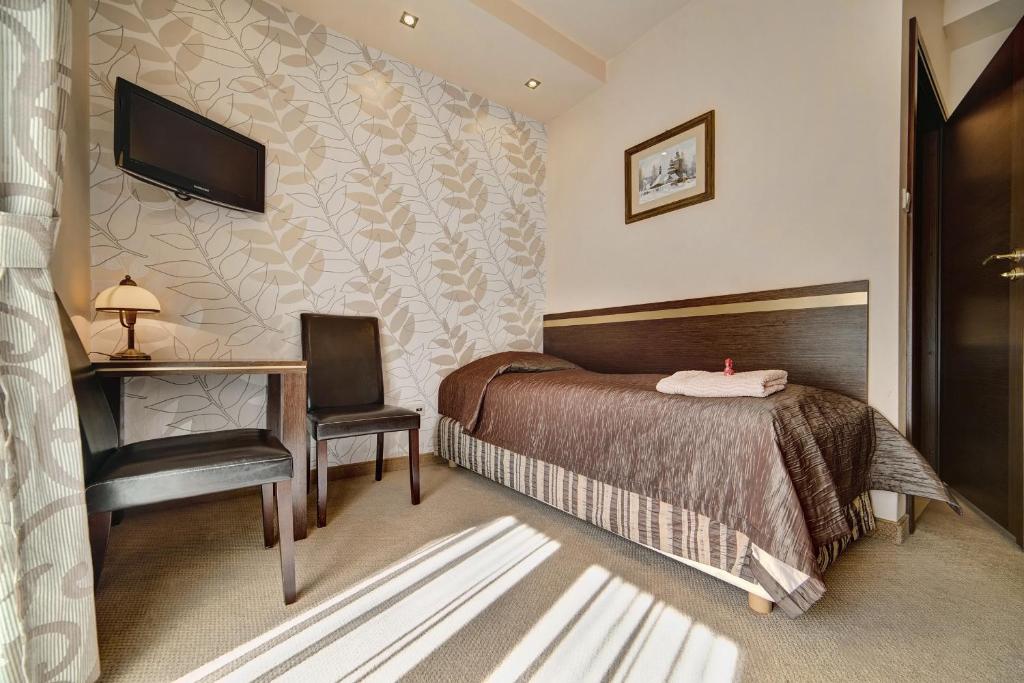 Posteľ alebo postele v izbe v ubytovaní Hotel Orlik